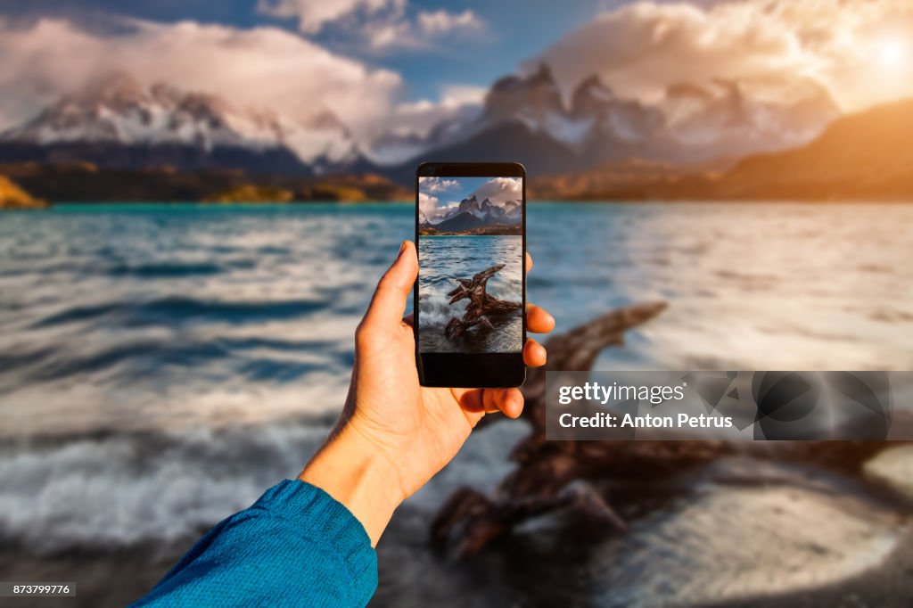 Photographing with smartphone in hand. Travel concept. Torres del Paine, Chili