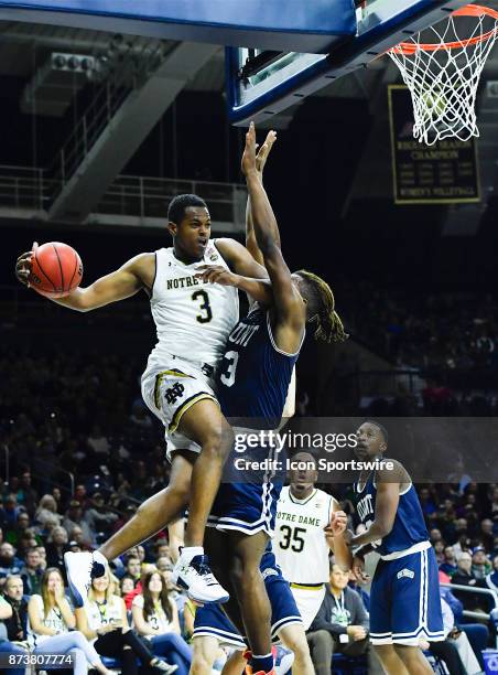 Notre Dame Fighting Irish guard D.J. Harvey passes the ball against Mount St. Mary's Mountaineers guard Greg Alexander during the game between the...