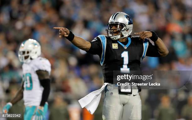 Cam Newton of the Carolina Panthers signals a first down against the Miami Dolphins in the first quarter during their game at Bank of America Stadium...