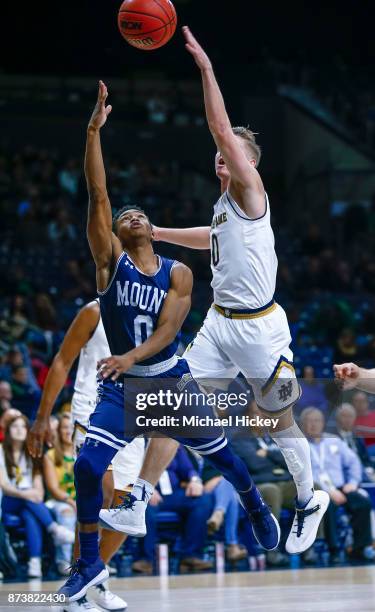Junior Robinson of the Mount St. Mary's Mountaineers shoots the ball as Rex Pflueger of the Notre Dame Fighting Irish makes the block at Purcell...