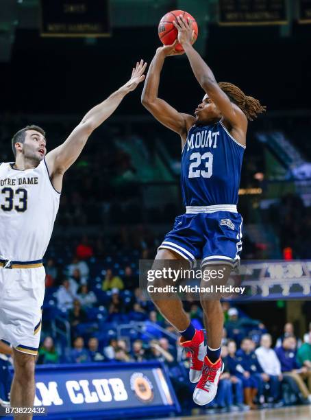 Greg Alexander of the Mount St. Mary's Mountaineers shoots the ball against John Mooney of the Notre Dame Fighting Irish at Purcell Pavilion on...