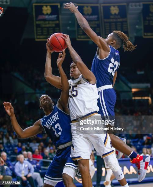 Bonzie Colson of the Notre Dame Fighting Irish tries to go up for a shot as Omar Habwe and Greg Alexander of the Mount St. Mary's Mountaineers defend...