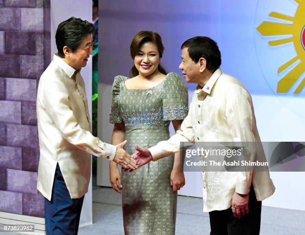 Japanese Prime Minister Shinzo Abe shakes hands with Philippines President Rodrigo Duterte prior to the ASEAN 50th Anniversary Ceremony on November...