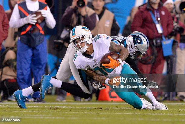 Kenny Stills of the Miami Dolphins runs the ball against James Bradberry of the Carolina Panthers in the first quarter during a game at Bank of...