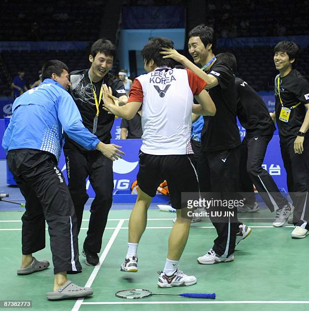 South Korea's Lee Yong Dae celebrates with teammates after winning over Indonesia's Hendra Setiawan and Mohammad Ahsan during the men's doubles...
