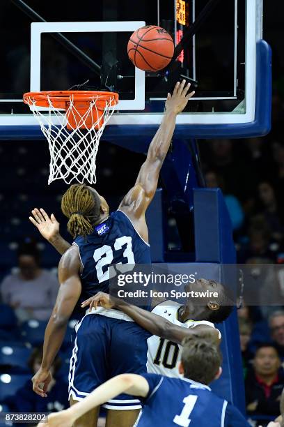 Mount St. Mary's Mountaineers guard Greg Alexander blocks the shot of Notre Dame Fighting Irish guard Temple Gibbs during the game between the Mount...