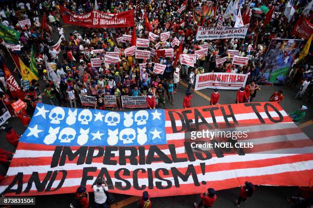 Protesters march towards the Malacanang Palace during a demonstration against US President Donald Trump attending the Association of Southeast Asian...