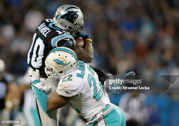 McDonald of the Miami Dolphins hits Curtis Samuel of the Carolina Panthers during their game at Bank of America Stadium on November 13, 2017 in...