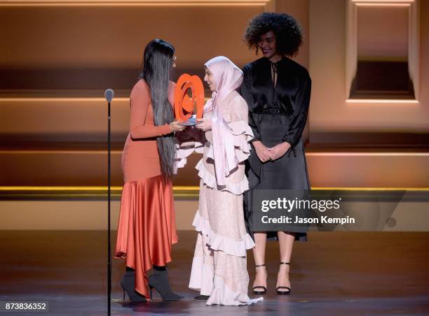 Lilly Singh presents Muzoon Almellehan with an award onstage at Glamour's 2017 Women of The Year Awards at Kings Theatre on November 13, 2017 in...