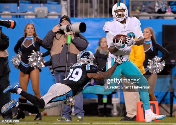 Mike Adams of the Carolina Panthers defends a pass to Julius Thomas of the Miami Dolphins in the second quarter during their game at Bank of America...