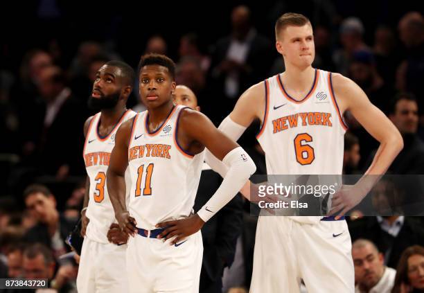 Tim Hardaway Jr. #3,Frank Ntilikina and Kristaps Porzingis of the New York Knicks react in the fourth quarter against the Cleveland Cavaliers at...
