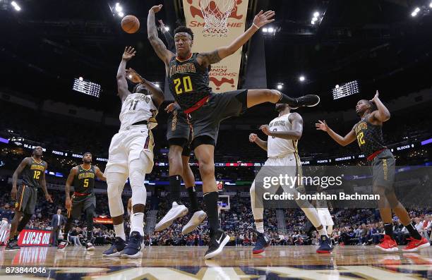 Jrue Holiday of the New Orleans Pelicans shoots the ball as John Collins of the Atlanta Hawks defends during the second half of a game at the...