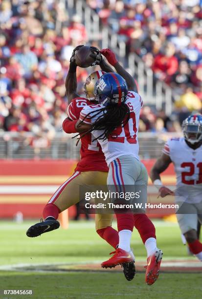 Aldrick Robinson of the San Francisco 49ers catches a pass in front of Janoris Jenkins of the New York Giants during their NFL football game at...