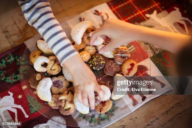 two children choosing traditional german christmas cookies - before christmas foto e immagini stock