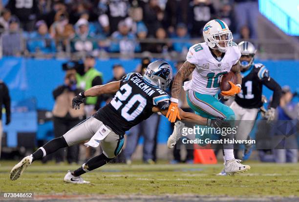 Kenny Stills of the Miami Dolphins runs the ball against Kurt Coleman of the Carolina Panthers in the third quarter during their game at Bank of...