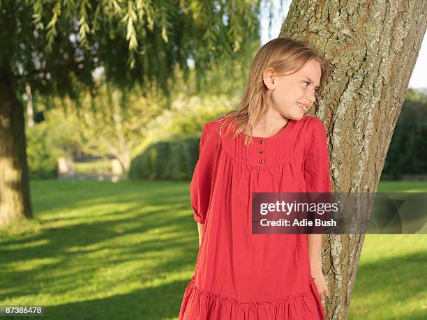 young girl hiding behind tree - girl hiding behind bush stock pictures, royalty-free photos & images