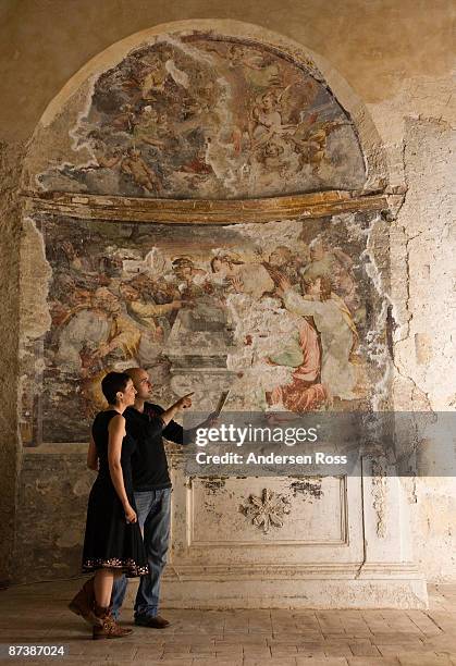 man and woman looking at fresco - fresco stock pictures, royalty-free photos & images