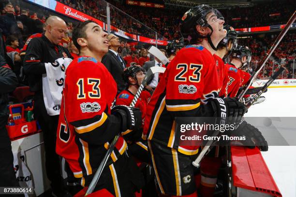 Johnny Gaudreau and Sean Monahan of the Calgary Flames looks at the replay in an NHL game against the St. Louis Blues at the Scotiabank Saddledome on...