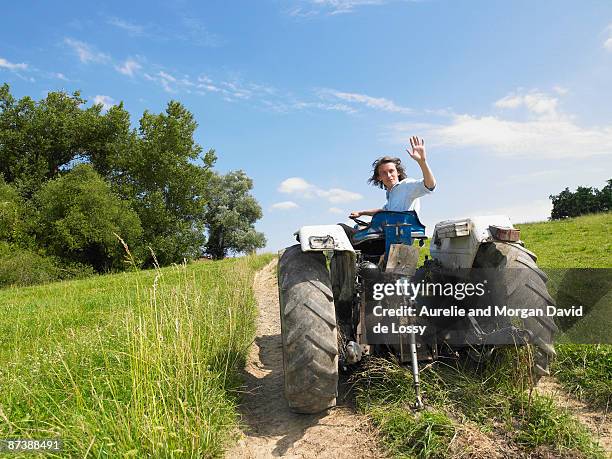 man driving tractor in field - lot y garona fotografías e imágenes de stock