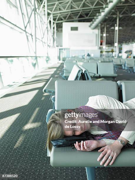woman sleeping on bench in airport - david de lossy sleep stock pictures, royalty-free photos & images