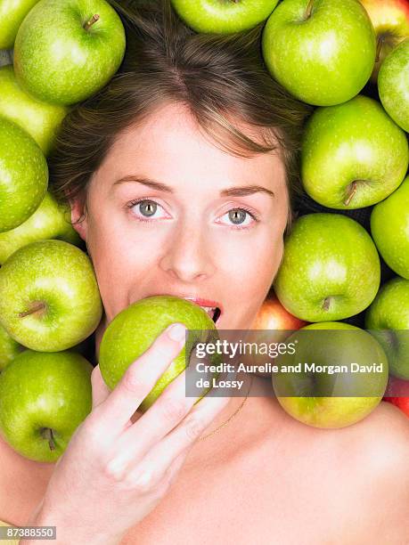 woman biting into apple - young women no clothes stock pictures, royalty-free photos & images