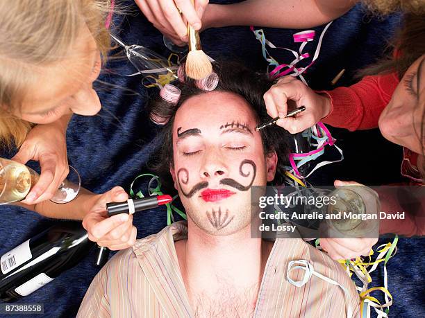 girls making up sleeping friend - after party mess stock pictures, royalty-free photos & images