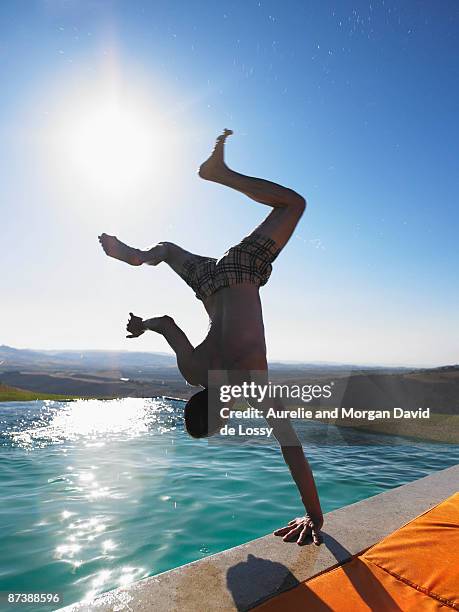 man jumping in swimming pool - man jumping into pool from behind stock pictures, royalty-free photos & images