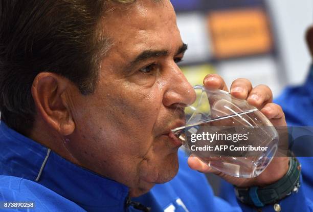Honduras' football coach Jorge Luis Pinto drinks water during a news conference in Sydney on November 14, 2017. Australia are banking on their extra...