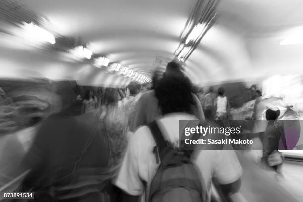 people going around the metro station's aisle - long exposure crowd stock pictures, royalty-free photos & images