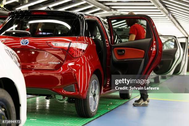 An employee works on the production line of the Toyota Motor Corp. Yaris at the company's plant in Onnaing, near Valenciennes, France, November 11,...