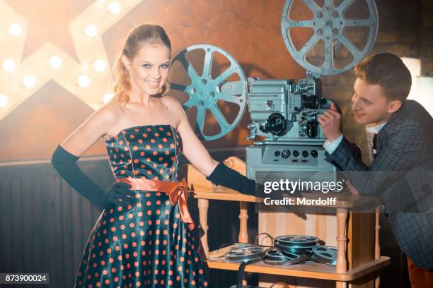 projectionist flirting with beautiful girl. old-fashioned image - projectionist stock pictures, royalty-free photos & images