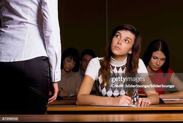 female student listening to teacher during school seminar - teachers pet stock pictures, royalty-free photos & images