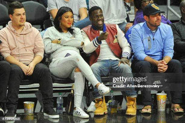 Actor Kevin Hart and wife Eniko Parrish attend a basketball game between the Los Angeles Clippers and the Philadelphia 76ers at Staples Center on...