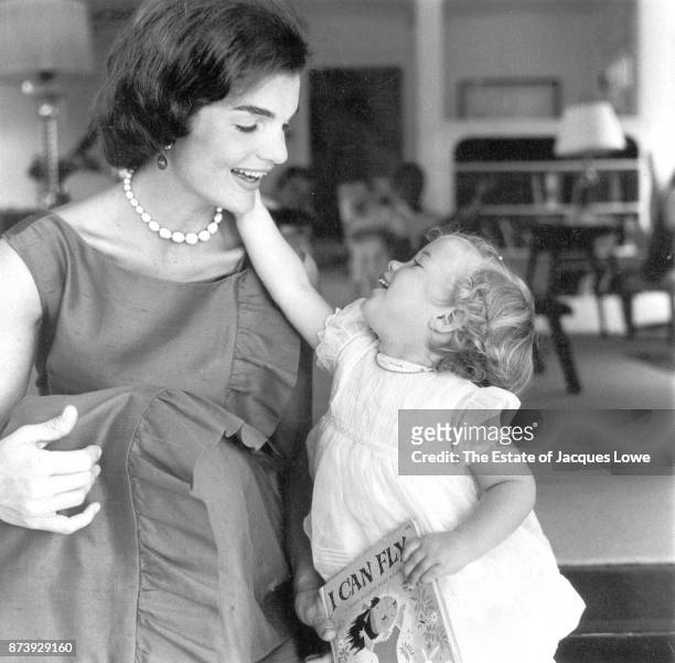 View of Jacqueline Kennedy and her daughter Caroline as they play together, Hyannis Port, Massachusetts, August 1960. The photo was taken during a...