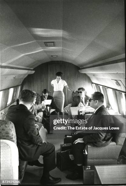 In his private plane , Senator John F Kennedy talks with various aides during a campaign trip through California, Spring 1960. Among those pictured...