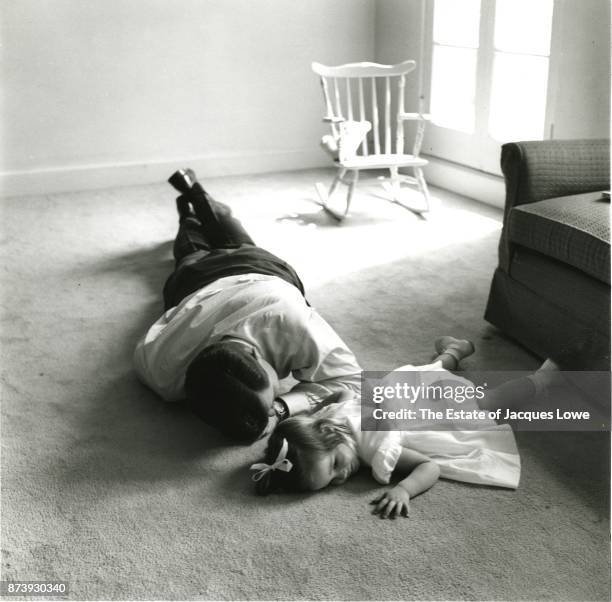 Senator John F Kennedy lies on the floor with his daughter Caroline, Hyannis Port, Massachusetts, late 1950s or early 1960s.