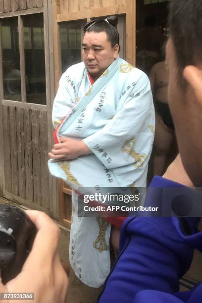 Mongolian sumo wrestler yokozuna, or grand champion, Harumafuji speaks with journalists after his morning training in Daizaifu city, Fukuoka...