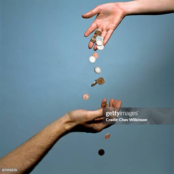 hands dropping coins - raining money foto e immagini stock