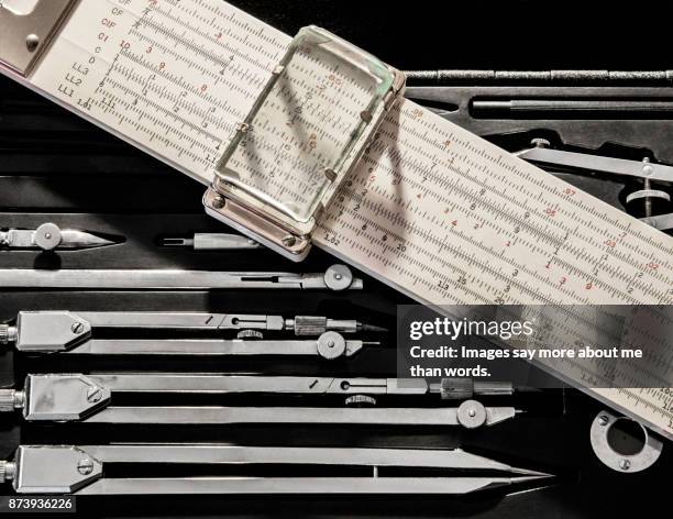 close up of mechanical calculating ruler and set of drawing compasses. - engenharia stock pictures, royalty-free photos & images