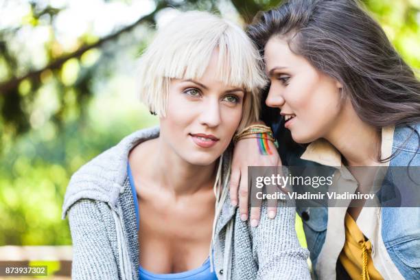 two friends talking in park - young love stock pictures, royalty-free photos & images