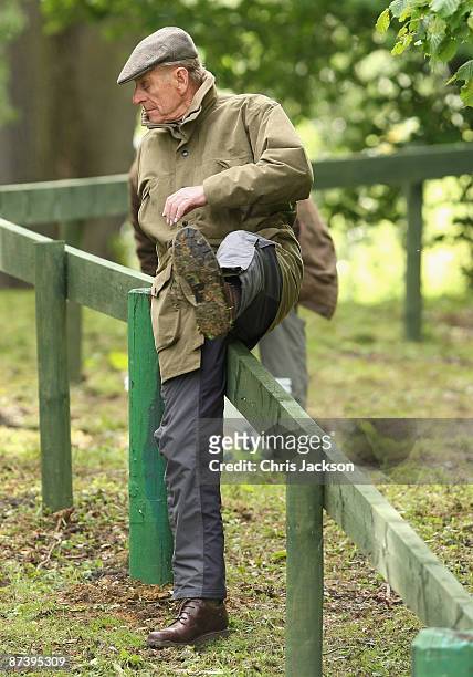 Prince Philip, Duke of Edinburgh climbs a fence as he prepares to judge the obstacles event during the Royal Windsor Horse Show 2009 on May 16, 2009...