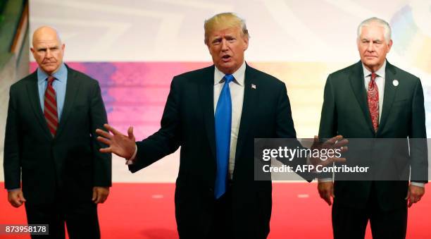 President Donald Trump gestures to the press as US National Security Advisor HR McMaster and US Secretary of State Rex Tillerson look on after...