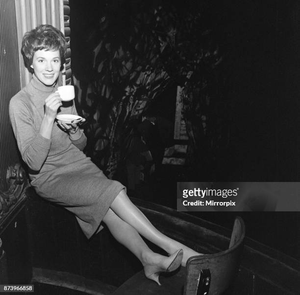 Julie Andrews watches her husband working on stage at the Lyric Theatre, Hammersmith. He is the stage and costume designer in William Brach's play 'A...