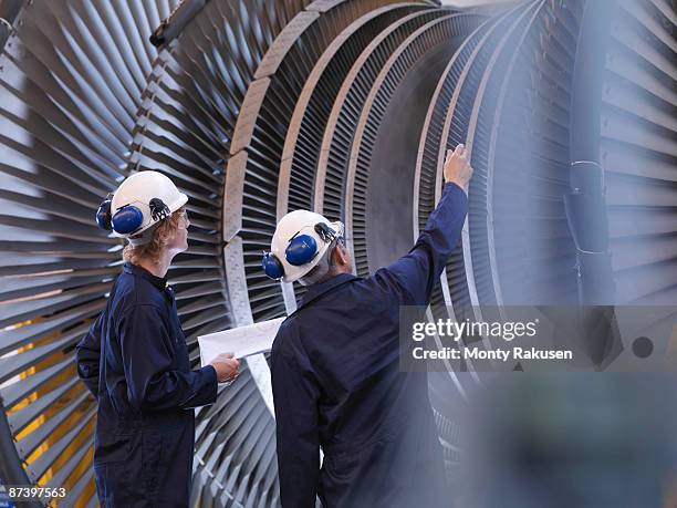 engineers looking at turbine - machinery imagens e fotografias de stock