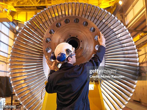 engineer inspecting turbine - turn stock pictures, royalty-free photos & images