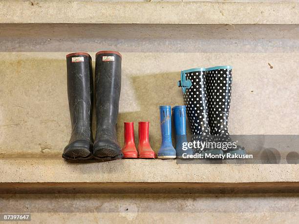 four pairs of wellington boots - sapatos sujos dentro de casa imagens e fotografias de stock
