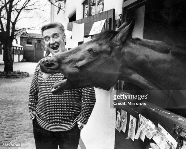 Legendary racehorse Red Rum and trainer Donald 'Ginger' McCain shar a joke at his Southport stable, following victory in the Grand national for a...
