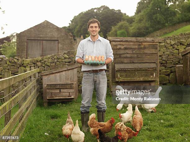 farmer with eggs, hens and geese - organic farming stock-fotos und bilder