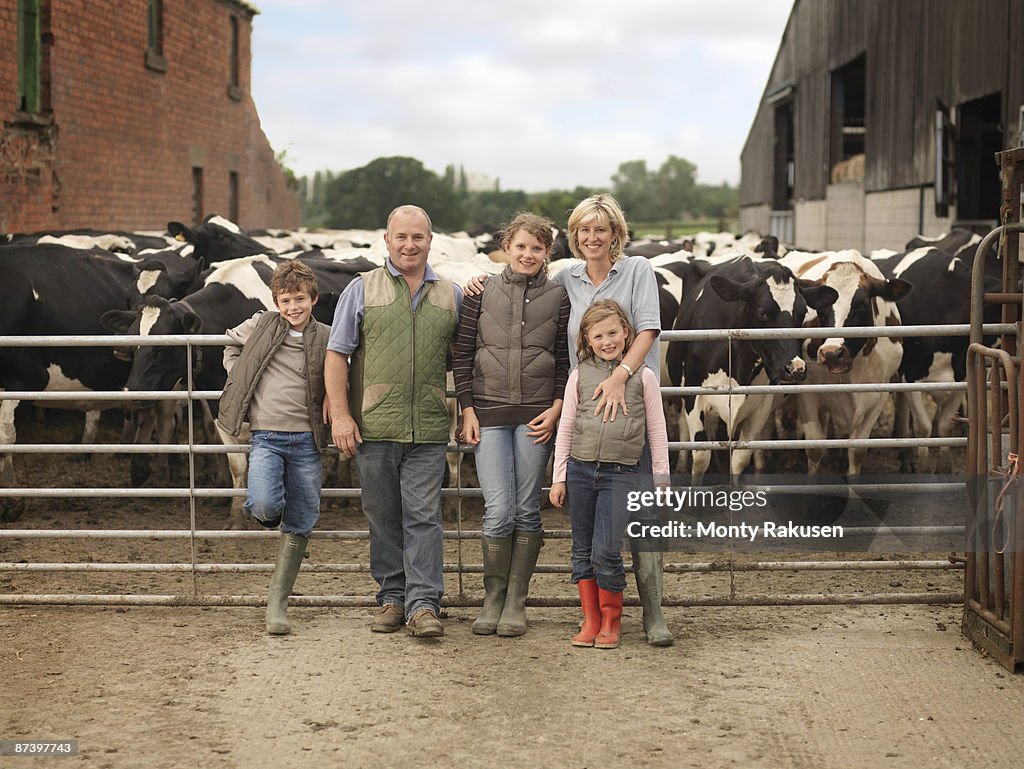 Farmer And Family With Cows