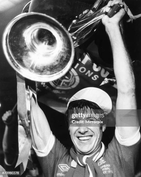 European Cup Final at Wembley Stadium. Club Brugge 0 v Liverpool 1. Liverpool's Emlyn Hughes holds aloft the European Cup trophy after their victory....